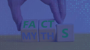 Hands arranging wooden blocks to spell the words facts and myths.